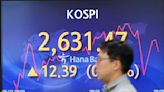 Stock market today: Asia shares rise as Fed holds rates steady while hinting of hikes ahead