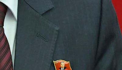 North Koreans are seen wearing Kim Jong Un pins for the first time as his personality cult grows