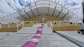 Portuguese street artist rolls out ‘banknote’ carpet to protest pope’s visit