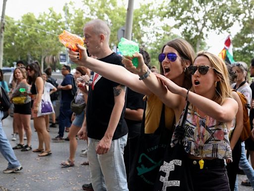 Furious anti-tourist protesters blast foreigners with WATER PISTOLS