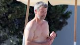 King Frederik of Denmark displays his two tattoos at the beach
