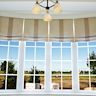 Roman shades are a classic and elegant type of window shade. They are made of fabric that folds up in horizontal pleats when raised. Roman shades are available in a variety of materials, including light filtering, blackout, and thermal options. They offer a soft, luxurious look and can be customized with different patterns and colors.