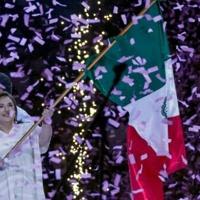 Mexican opposition presidential candidate Xochitl Galvez, polling in second place on the eve of elections, waves the national flag during a campaign rally