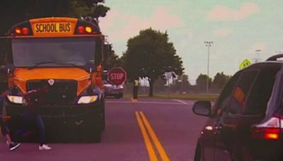 Stopped school bus. Oncoming emergency vehicle. What should I do?