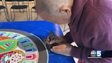 Visiting Tibetan monk working on mandala in Brattleboro