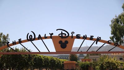 Walt Disney warns theme park revenue to fall, profit slips