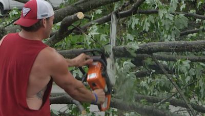 Neighbors clean debris after Sunday’s first wave of storms