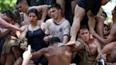 Watch live: US Naval academy freshmen attempt to climb 21ft greasy pole in human pyramid