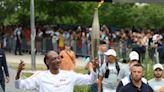 Snoop Dogg carries the Olympic torch before opening ceremony in Paris