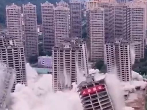 Moment abandoned high rises are DEMOLISHED after builders ‘ran out of cash’