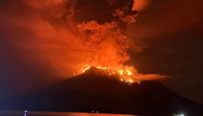 Indonesia: Volcano eruption turns night sky red as lightning strikes around Mount Ruang