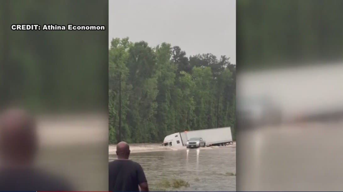 When all you see is truck top, it's time to go! Game Wardens helping families evacuate floodwaters