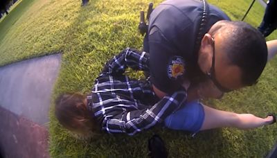 Video shows cops holding a mom down in bed of fire ants as they attacked her face and she pleaded for help