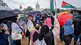 Hundreds of pro-Palestinian protesters rally in the rain in DC to mark a painful present and past