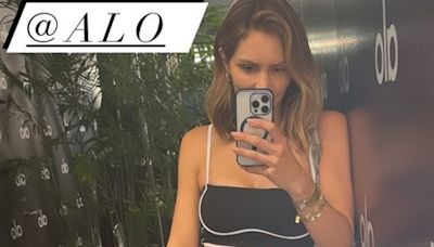 Katharine McPhee bares taut tummy in a black sports bra and leggings