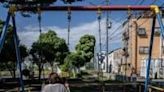 A divorced woman sits on a children's swing set during an interview with AFP at a location in central Japan