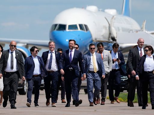 Awkward moment JD Vance attempts to confront Kamala on tarmac – before holding presser in front of Air Force 2