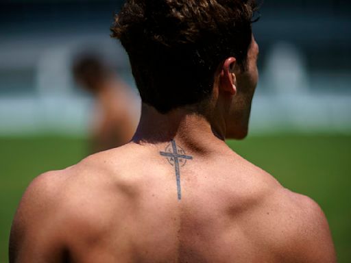 At the Olympics, athletes show guts, glory – and a lot of ink, including tattoos that profess their faith