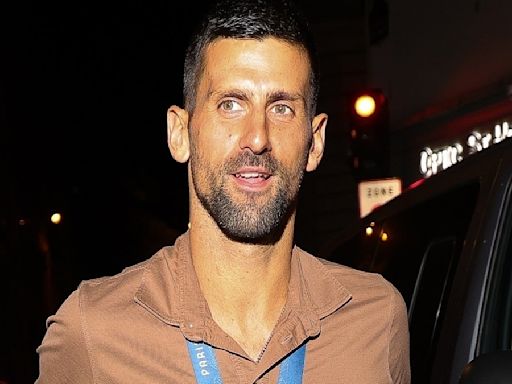 Novak Djokovic wears his Olympic gold medal during a night in Paris