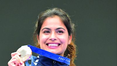 Manu Bhaker poses with her bronze medal in the 10m air pistol women’s final round at the 2024 Summer Olympics, on Sunday. Bhaker became the first Indian woman shooter to claim an Olympic medal, a triumph that opened the country’s account in the Paris...