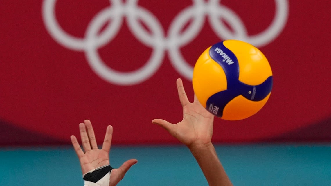 Why does one volleyball player wear a different color jersey at the Olympics?