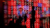 European shares lower on earnings, bonds boosted after Fed