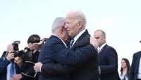 Israel Prime Minister Benjamin Netanyahu hugs US President Joe Biden upon his arrival at Tel Aviv's Ben Gurion airport on October 18, 2023