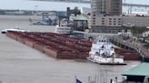 Near-miss on the Mississippi River as towboat narrowly escapes collision of barges, boats and docks