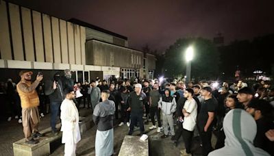 Hundreds gather outside police station as anger rises over video of officer kicking man in head at Manchester Airport