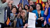 Arizona's Democratic governor signs a bill to repeal 1864 ban on most abortions