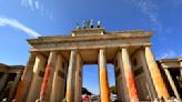 Climate activists spray Berlin's Brandenburg Gate with orange paint