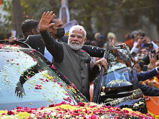 Indian PM Modi steals limelight at lavish Ambani wedding as route to the ceremony lined with posters