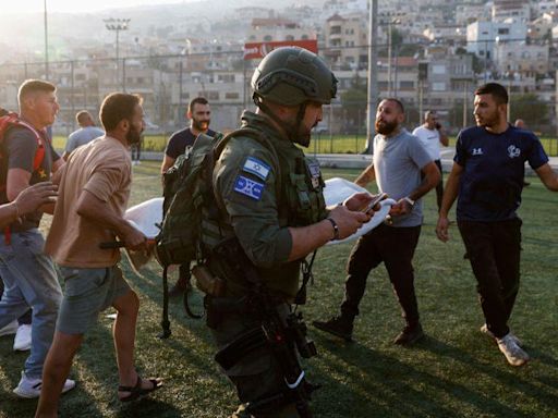 Israel hits Hezbollah targets after football pitch strike kills 12 young people