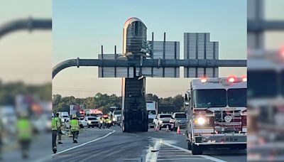 Inattentive Trucker Gets His Trailer Hung Up On A Highway Sign