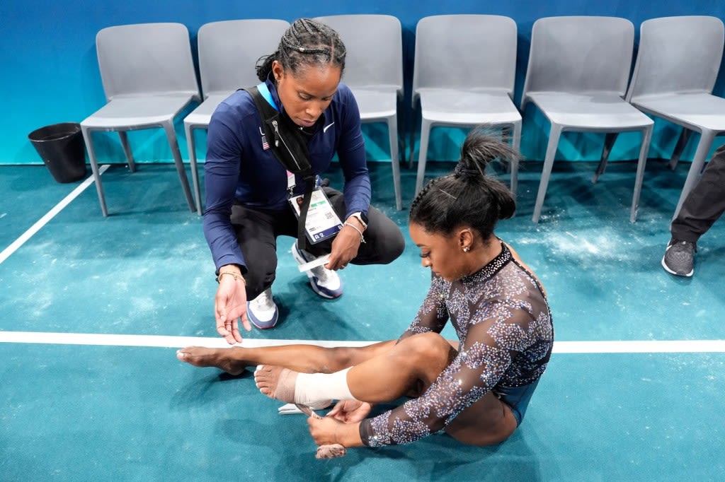 Simone Biles leaves gymnastics arena limping after team prelims