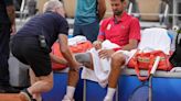 Novak Djokovic’s knee injury bothers him at the Paris Olympics but he beats Stefanos Tsitsipas