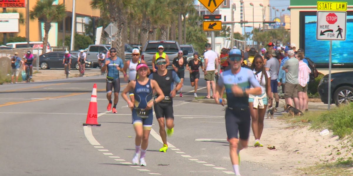 Athletes cross the finish line at IRONMAN 70.3 Gulf Coast