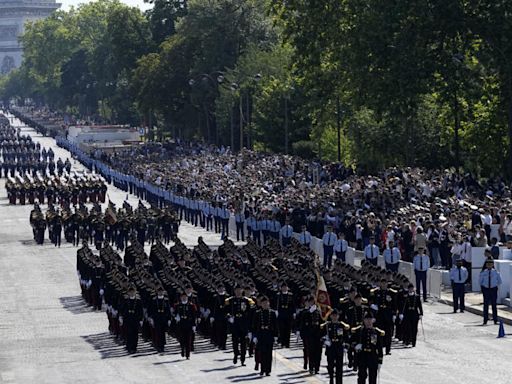 Olympic flame relay merges with Bastille Day parade in a big year for France