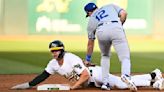 The Oakland Athletics' Zack Gelof steals second base under Kansas City Royals infielder Nick Loftin in the third inning at Oakland Coliseum on Tuesday, June 18, 2024, in Oakland...