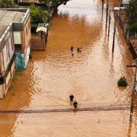 Aerial view of people walking through a flooded street at the Navegantes neighborhood in Porto Alegre, Rio da Grande do State, Brazil