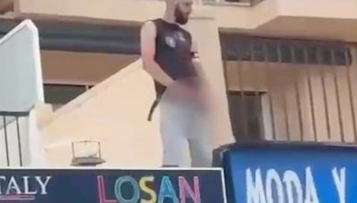 Moment drunk German fan URINATES from first-floor balcony onto Majorca street