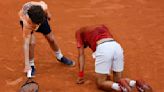 Novak Djokovic wins his record 370th Slam match but isn't sure he can continue at the French Open