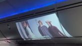 Airline Passenger Uses Projector to Watch Movie on Plane's Overhead Bin