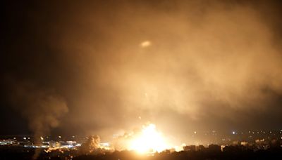 Israeli airstrikes rock southern suburbs of Beirut and cut off a key crossing into Syria