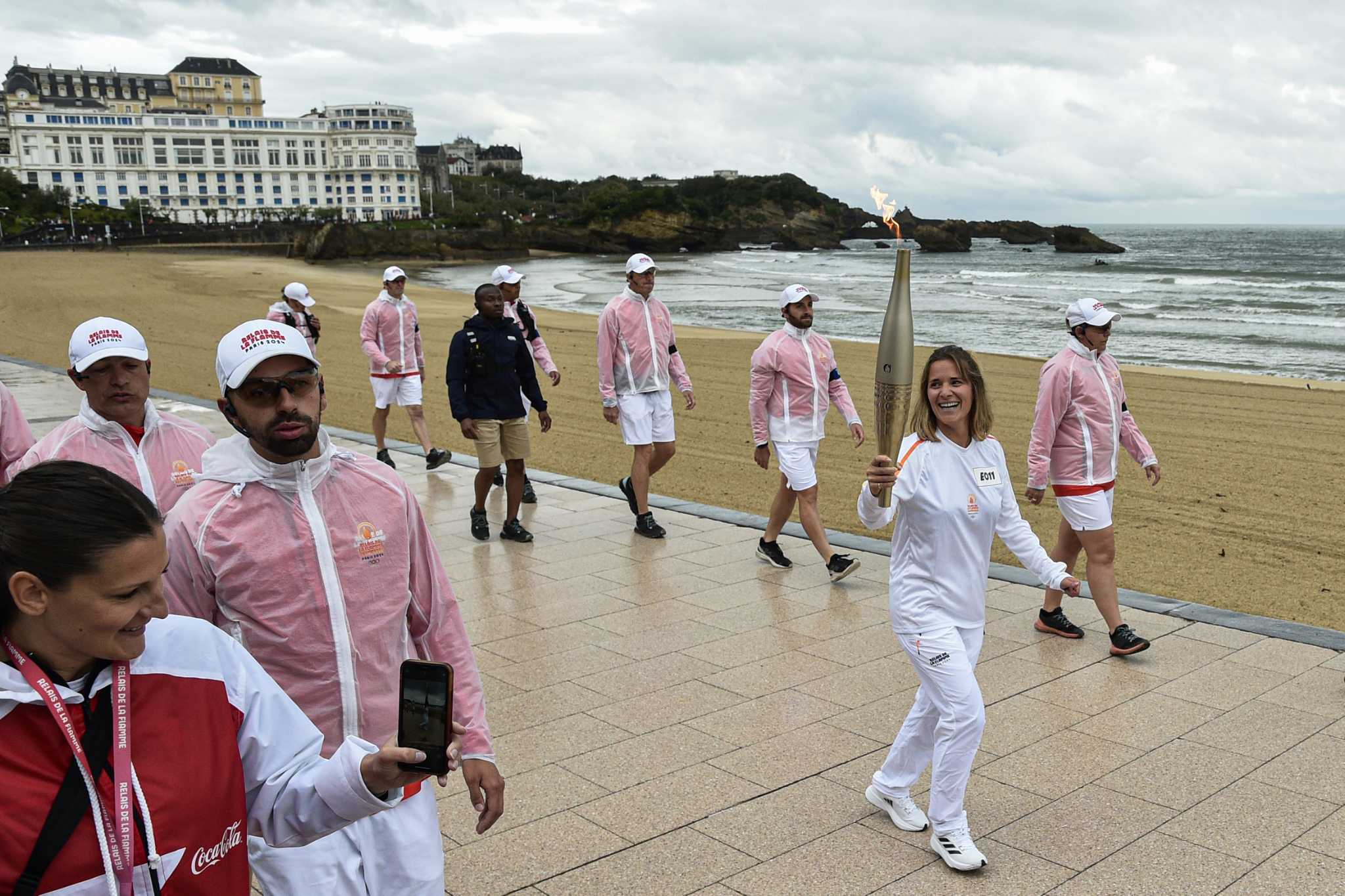 Man is held in France over posts about California murders as Olympic torch passes through Bordeaux