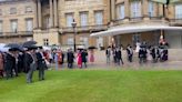 Prince of Wales hosts wet Buckingham Palace garden party