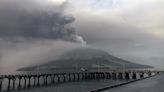 Indonesians leave homes near erupting volcano and airport closes due to ash danger