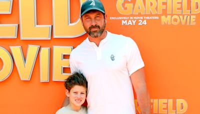 Maksim Chmerkovskiy hits the orange carpet with son Shai for 'Garfield' premiere