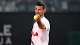 Novak Djokovic returns to Rome practice with helmet after injury signing autographs | Tennis.com