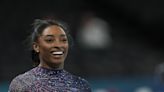 Simone Biles is on the Olympic gymnastics competition floor in front of a star-studded crowd